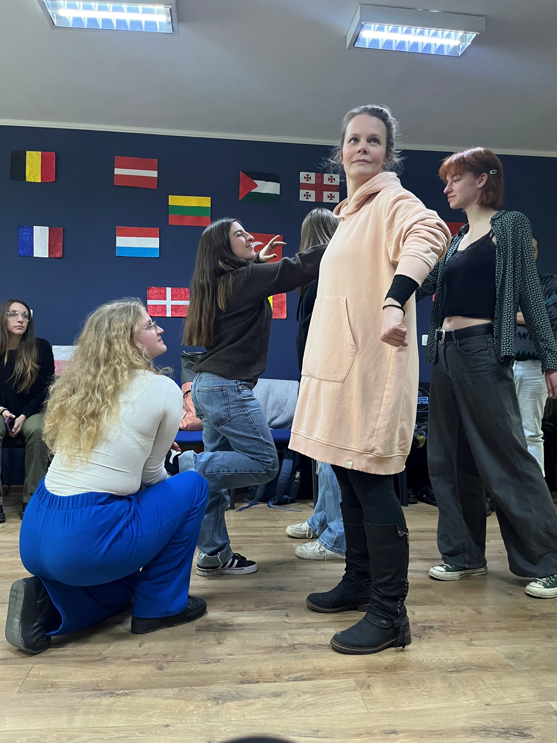 Ysi-Act project testing creative methods A snapshot of creative method testing, showing a group of people in various poses. Laura is standing in the center.
