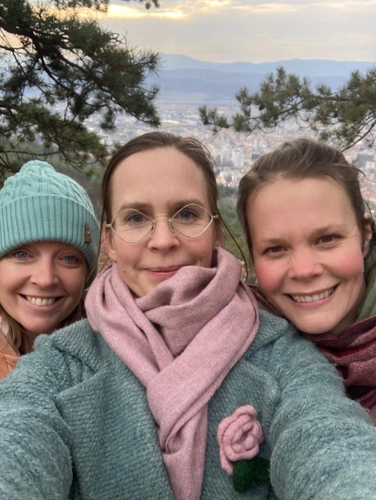 Ysi-Act project Laurea UAS Kaisa, Niina and Laura in the group photo. A cityscape can be seen in the background.